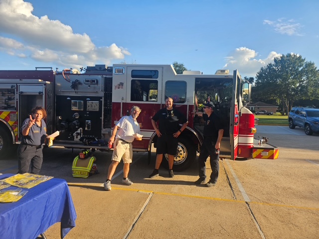 North Forest neighbors and firefighters standing beside a fire engine at the 2026 National Night Out